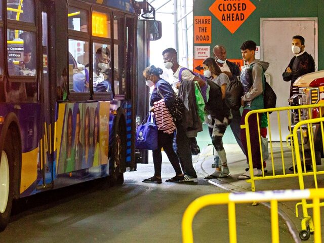 Migrants leave for a shelter from the Port Authority bus terminal in New York, the United