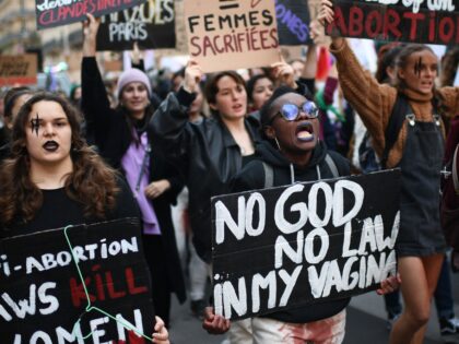 Demonstrators hold placards as they take part in an abortion rights rally on the annual In