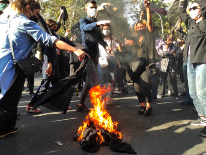 TEHRAN, IRAN - OCTOBER 01: (EDITORS NOTE: Image taken with mobile phone camera.) Iranian protesters set their scarves on fire while marching down a street on October 1, 2022 in Tehran, Iran. Protests over the death of 22-year-old Iranian Mahsa Amini have continued to intensify despite crackdowns by the authorities, …