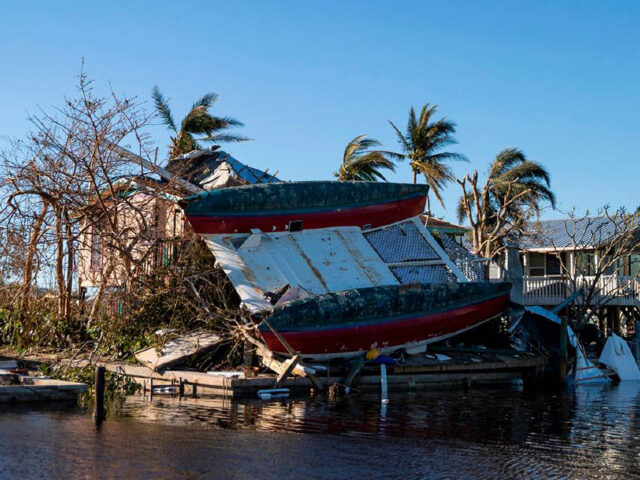 A catamaran sits on top of a home in a canal on Friday, Sept. 30, 2022, in St. James City,