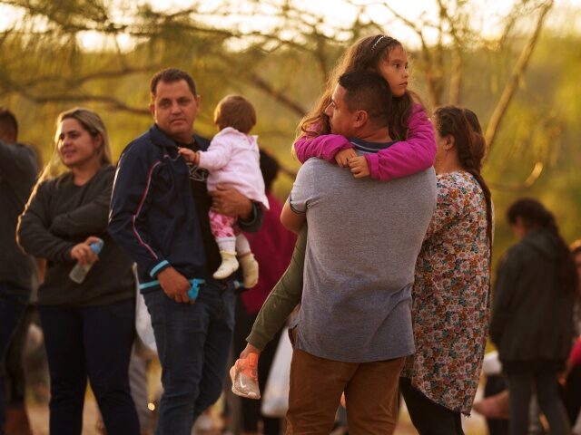 A father holds his daughter after they illegally crossed the US southern border with Mexic