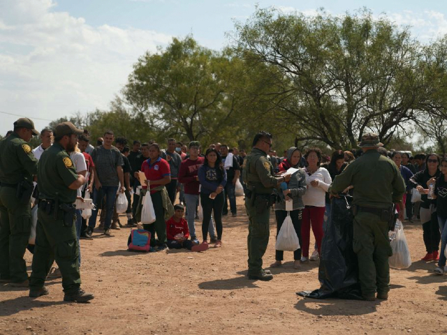 This picture taken on October 9, 2022 shows migrants being processed by US Border Patrol after they illegally crossed the US southern border with Mexico in Eagle Pass, Texas. - In the 2022 fiscal year US Customs and Border Patrol (CBP) has had over 2 million encounters with migrants at the US-Mexico border, setting a new record in CBP history. (Photo by allison dinner / AFP) (Photo by ALLISON DINNER/AFP via Getty Images)