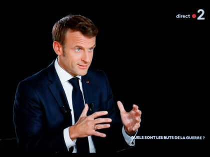 French president Emmanuel Macron gestures as he speaks during an interview as part of a new show entitled "L'evenement", in Saint-Denis, northern Paris, on October 12, 2022. - Emmanuel Macron is to give an hour-long interview on France 2, devoted to international crises and France's place in the world: on …