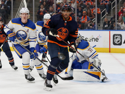 Evander Kane #91 of the Edmonton Oilers and Rasmus Dahlin #26 of the Buffalo Sabres look on during a game on October 18, 2022 at Rogers Place in Edmonton, Alberta, Canada. (Photo by Lawrence Scott/Getty Images)