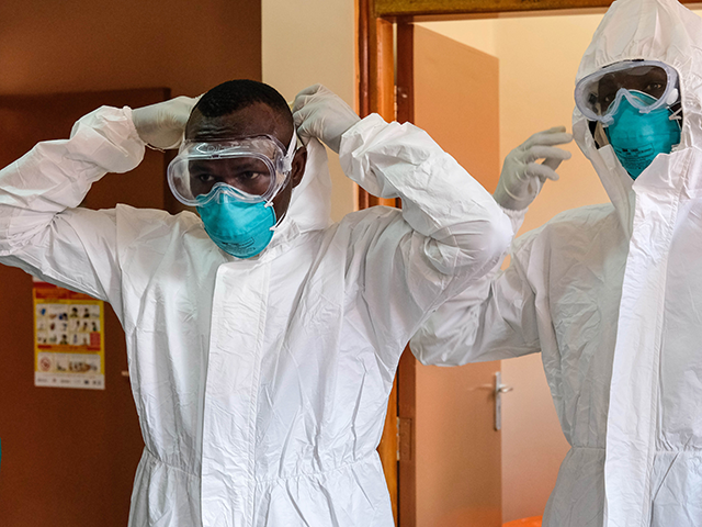 Doctors put on protective equipment at Entebbe Regional Referral Hospital in Entebbe, Uganda, on Oct. 20, 2022. Uganda is grappling with Ebola since the index case was announced on Sept. 20. The Ministry of Health figures issued Thursday showed that the country has registered 64 confirmed Ebola cases and 25 …