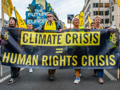People are holding a banner from Amnesty International, during a massive climate demonstration organized in Brussels, on October 23rd, 2022. (Photo by Romy Arroyo Fernandez/NurPhoto via Getty Images)