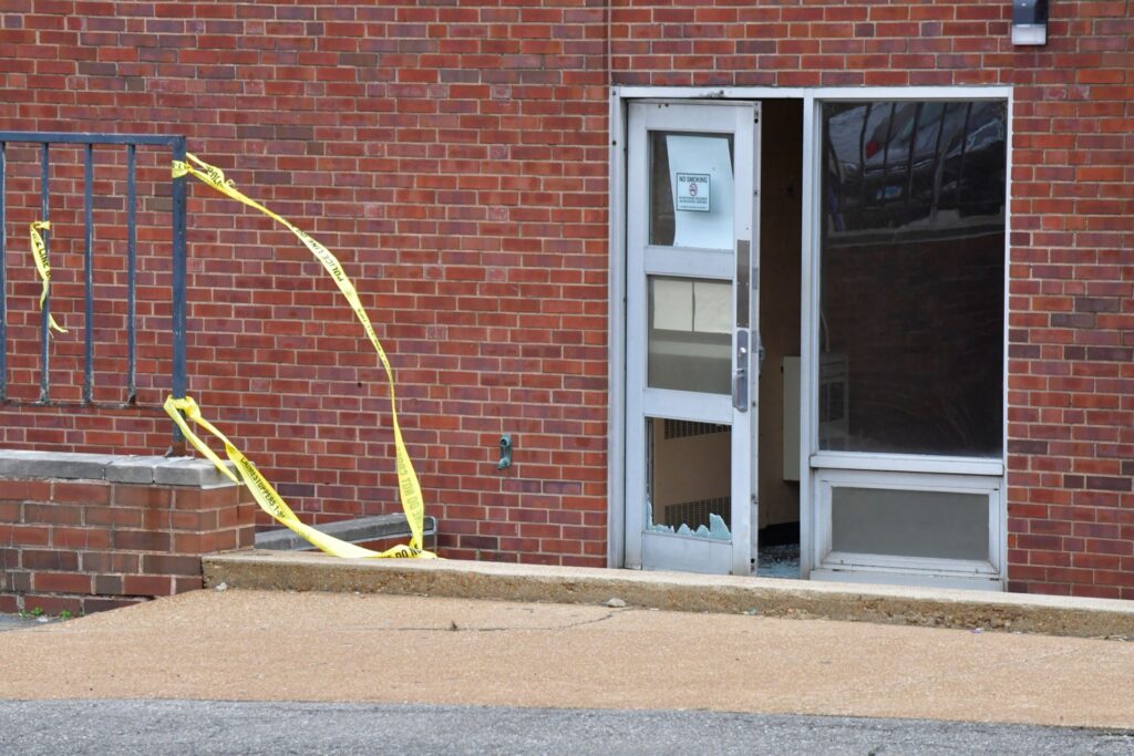 Broken glass in the entrance on the north side of the Central Visual and Performing Arts High School after a shooting that left three people dead including the shooter in St Louis, Missouri on October 24, 2022. - Two people were killed on Monday and several were injured by a gunman who opened fire at a high school in the midwestern US city of St. Louis, police said. (Photo by TIM VIZER / AFP) (Photo by TIM VIZER/AFP via Getty Images)