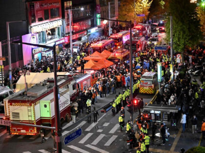 Crowds are seen around the area, where dozens of people suffered cardiac arrest, in the popular nightlife district of Itaewon in Seoul on October 30, 2022. - Dozens of people suffered from cardiac arrest in the South Korean capital Seoul, after thousands of people crowded into narrow streets in the …