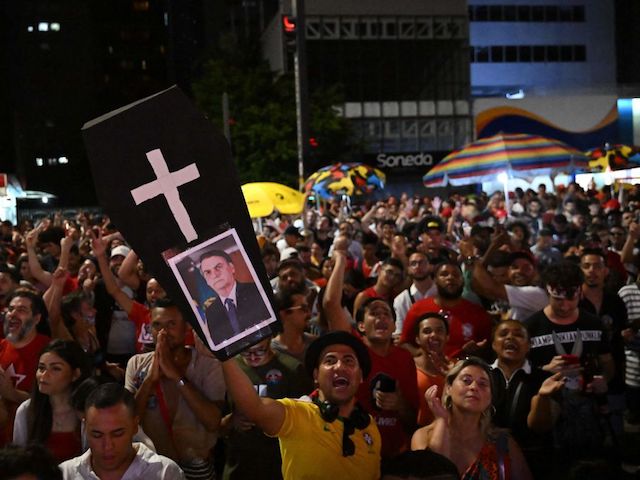 Supporters of Brazilian former President (2003-2010) and candidate for the leftist Workers Party (PT) Luiz Inacio Lula da Silva celebrate while watching the vote count of the presidential run-off election at the Paulista avenue in Sao Paulo, Brazil, on October 30, 2022. (Photo by CARL DE SOUZA / AFP) (Photo by CARL DE SOUZA/AFP via Getty Images)