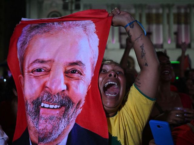 A supporter of Brazilian former President (2003-2010) and candidate for the leftist Workers Party (PT) Luiz Inacio Lula da Silva celebrates after her candidate won the presidential runoff election at the Cinelandia square in Rio de Janeiro, Brazil, on October 30, 2022. - Brazil's veteran leftist Luiz Inacio Lula da Silva was elected president Sunday by a hair's breadth, beating his far-right rival in a down-to-the-wire poll that split the country in two, election officials said. (Photo by Pablo PORCIUNCULA / AFP) (Photo by PABLO PORCIUNCULA/AFP via Getty Images)