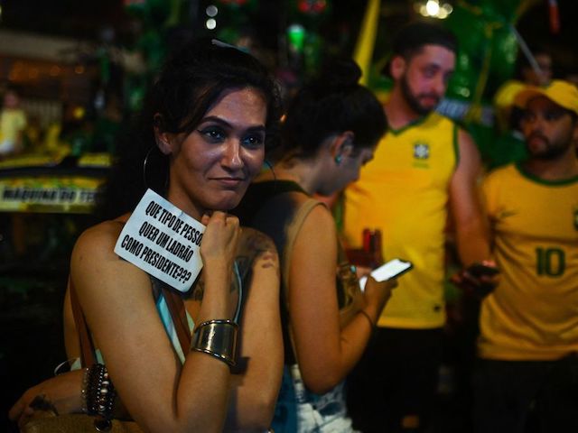 Supporters of Brazilian President and re-election candidate Jair Bolsonaro react after their candidate lost the presidential runoff election in Rio de Janeiro, Brazil, on October 30, 2022. - Brazil's veteran leftist Luiz Inacio Lula da Silva was elected president Sunday by a hair's breadth, beating his far-right rival in a down-to-the-wire poll that split the country in two, election officials said. (Photo by ANDRE BORGES / AFP) (Photo by ANDRE BORGES/AFP via Getty Images)