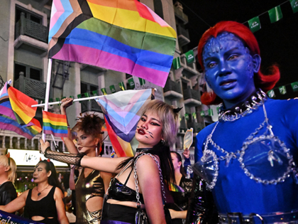 LGBTQIA+ members and activists in costumes take part in a parade during Halloween celebrations at popular tourist street Khaosan Road in Bangkok on October 31, 2022. (Photo by Lillian SUWANRUMPHA / AFP) (Photo by LILLIAN SUWANRUMPHA/AFP via Getty Images)