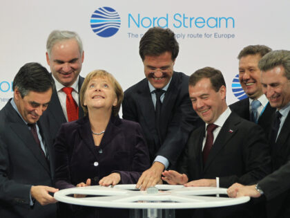 LUBMIN, GERMANY - NOVEMBER 08: (From L to R, first row) French Prime Minister Francois Fillon, German Chancellor Angela Merkel, Dutch Prime Minister Mark Rutte, Russian President Dmitry Medvedev and European Union Energy Commissioner Guenther Oettinger turn a wheel to symbolically start the flow of gas through the Nord Stream …