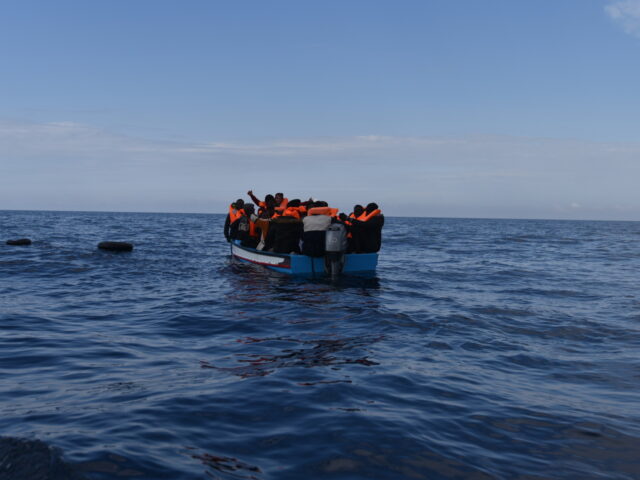 SAR LIBYA, SPAIN - MARCH 05: Migrants in a wooden boat, which left the coast of Libya, are