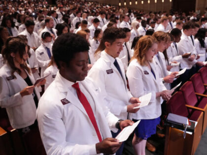 MINNEAPOLIS, MN. - AUGUST 2022: Medical student Nobles Antwi and his classmates recite an oath they wrote together during the University of Minnesota Medical Schools annual White Coat Ceremony for the class of 2026 Friday, Aug. 19, 2022 at the Northrop Memorial Auditorium on the University campus in Minneapolis. The …