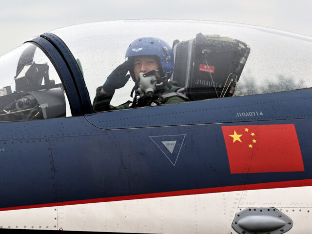 CHANGCHUN, CHINA - AUGUST 29: A pilot in a J-10 fighter jet of the Bayi Aerobatics Team of