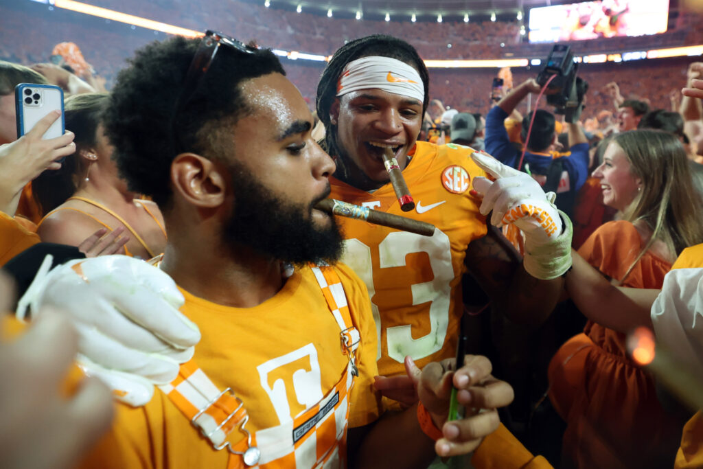 Linebacker Jeremy Banks #33 of the Tennessee Volunteers gets a cigar from a fan after the game against the Alabama Crimson Tide at Neyland Stadium on October 15, 2022 in Knoxville, Tennessee. Tennessee won the game 52-49. (Photo by Donald Page/Getty Images)