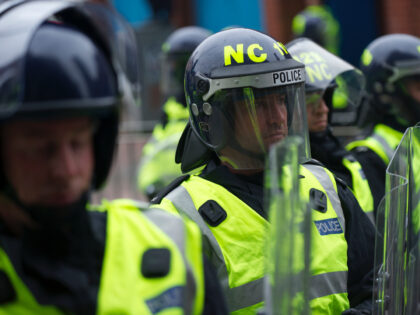 A phalanx of police officers, numbering in excess of 1,400, equipped with riot gear and security dogs, kept a rally of 1,000 English Defence League (EDL) members under control in Leicester, England on October 9, 2010. Bricks and smoke bombs were thrown at police and several arrests were made in …