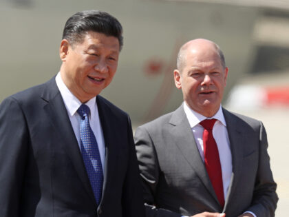 HAMBURG, GERMANY - JULY 06: Chinese President Xi Jinping (L) chats with Hamburg Mayor Olaf Scholz upon Xi's arrival at Hamburg Airport for the Hamburg G20 economic summit on July 6, 2017 in Hamburg, Germany. Leaders of the G20 group of nations are meeting for the July 7-8 summit. Topics …