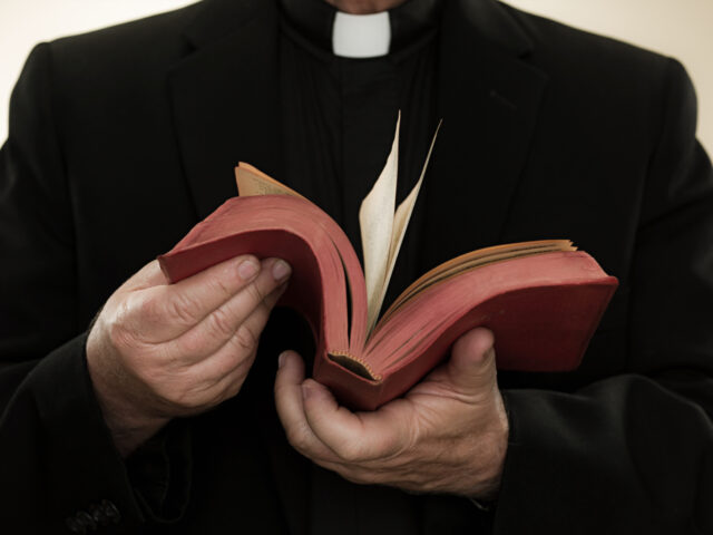 Priest holding a bible