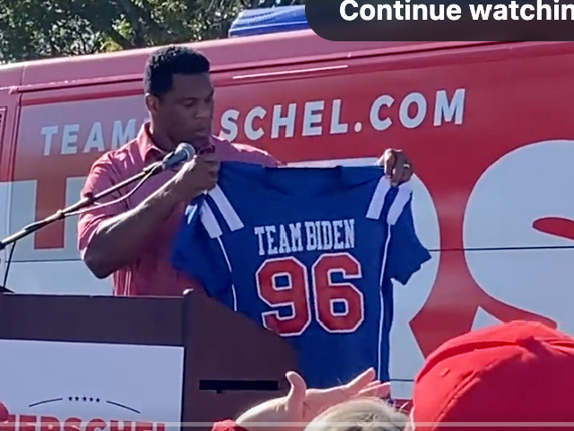 Herschel Walker Holds Up Team Biden Jersey for Warnock