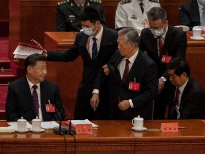 Chinese President Xi Jinping (L) looks on as former President Hu Jintao is helped to leave early from the closing session of the 20th National Congress of the Communist Party of China, at The Great Hall of People on October 22, 2022 in Beijing, China's Communist Party Congress is concluding …