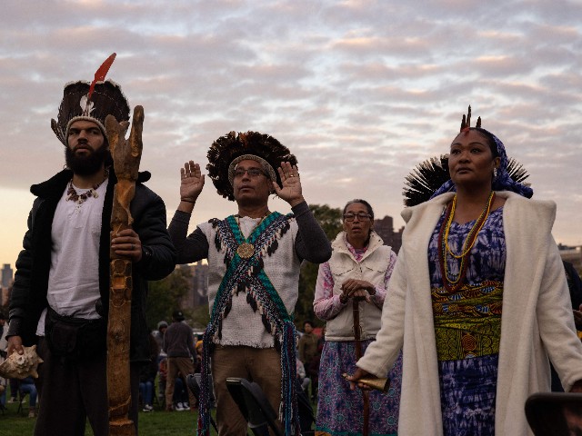 People gather on Randall's Island in New York City on October 10, 2022, to participate in an Indigenous Peoples' Day sunrise ceremony. - The federal holiday to mark Columbus Day is also officially recognized as Indigenous Peoples' Day, following a proclamation by US President Joe Biden. (Photo by Yuki IWAMURA / AFP) (Photo by YUKI IWAMURA/AFP via Getty Images)
