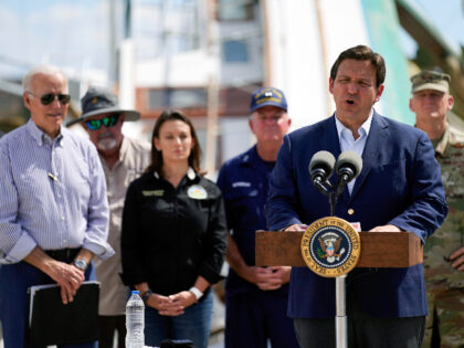 President Joe Biden listens as Florida Gov. Ron DeSantis speaks after they toured an area impacted by Hurricane Ian on Wednesday, Oct. 5, 2022, in Fort Myers Beach, Fla. (AP Photo/Evan Vucci)