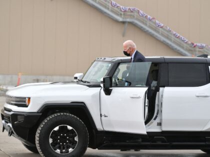 Joe Biden climbing into an electric Hummer