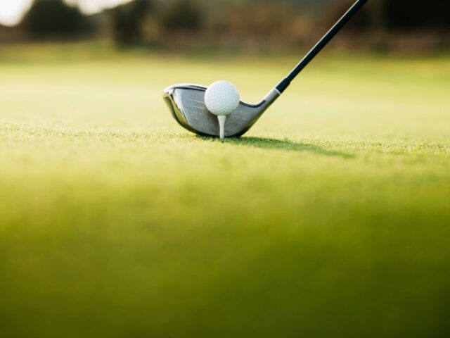 Close-Up Of Golf Ball On tee on a golf course - stock photo