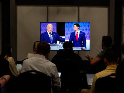 Members of the media watch Arizona Democratic Sen. Mark Kelly, left, and his Republican ch