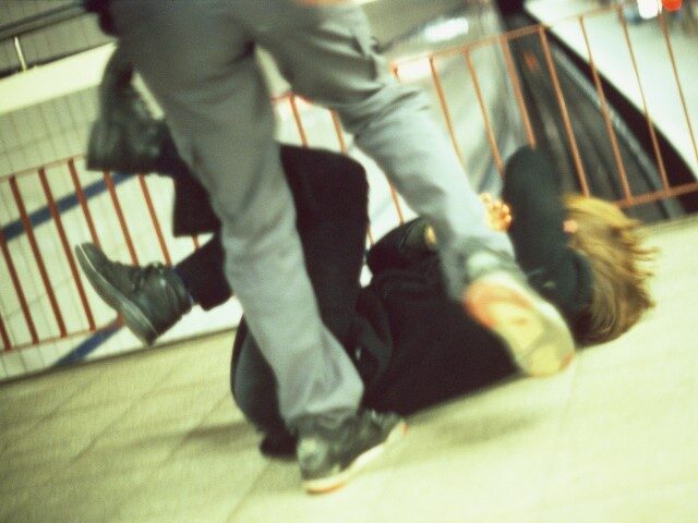 Man kicking woman in subway station (Mikael Vaisanen / The Image Bank via Getty)