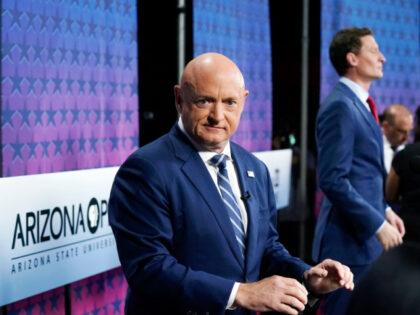 Arizona Democratic Sen. Mark Kelly, left, and his Republican challenger Blake Masters, right, pause on stage prior to a televised debate in Phoenix, Thursday, Oct. 6, 2022. (AP Photo/Ross D. Franklin)