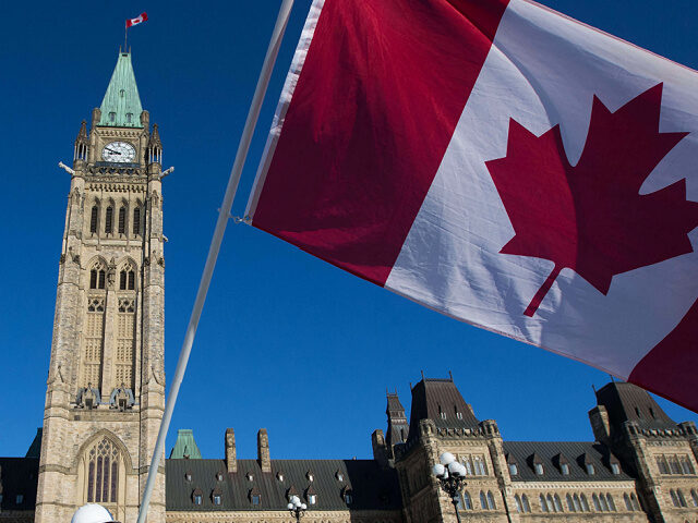 Men wear a yellow vests and wave the Canadian flag on Parliament Hill before the planned C