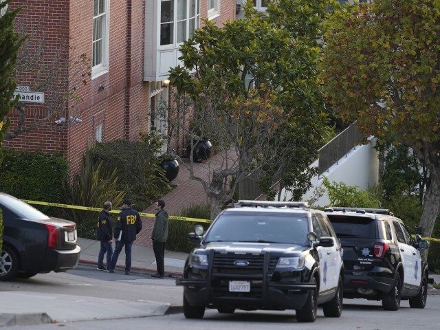 A pair of FBI agents work outside the home of Paul Pelosi, the husband of House Speaker Na