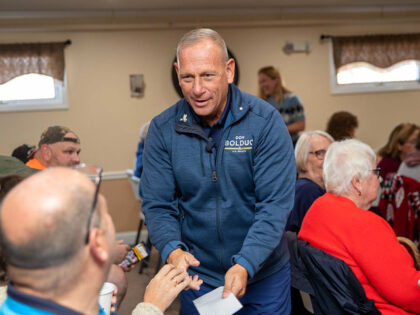 DERRY, NH - OCTOBER 15: Republican senate nominee Don Bolduc shakes hands with attendees d