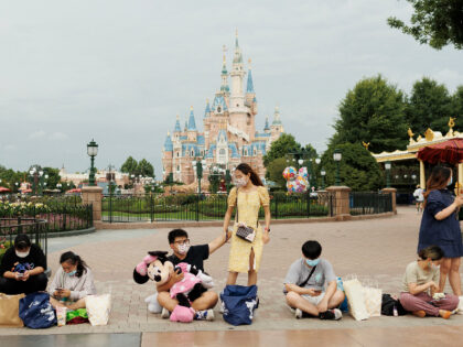SHANGHAI, CHINA - JUNE 30: People rest infront of the Enchanted Storybook Castle at Shanghai Disneyland on June 30, 2022 in Shanghai, China. (Photo by Hu Chengwei/Getty Images)