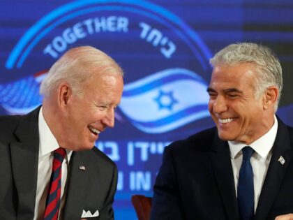 US President Joe Biden (L) and Israel's caretaker Prime Minister Yair Lapid, smile after signing a security pledge in Jerusalem, on July 14, 2022. (Photo by Atef SAFADI / POOL / AFP) (Photo by ATEF SAFADI/POOL/AFP via Getty Images)