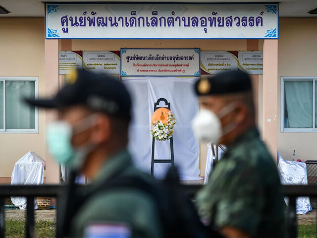 NONG BUA LAMPHU, THAILAND - OCTOBER 07: Emergency personnel walk past a flower wreath plac