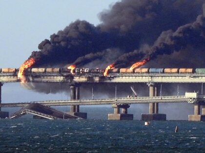 Black smoke billows from a fire on the Kerch bridge that links Crimea to Russia, after a t