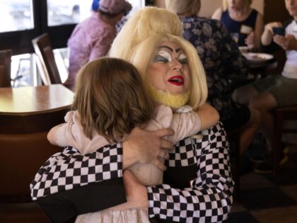 Ginger Forest hugs 4-year-old Lily Kornfeind during story time with drag queens at brunch at Jerry&apos;s Sandwiches in Chicago&apos;s Lincoln Square on Sept. 18, 2022. (Erin Hooley/Chicago Tribune/Tribune News Service via Getty Images)