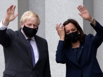 WASHINGTON, DC - SEPTEMBER 21: U.S. Vice President Kamala Harris (R) and British Prime Minister Boris Johnson (L) wave as they tour the balcony outside the Vice President’s ceremonial office at Eisenhower Executive Building during a meeting on September 21, 2021 in Washington, DC. Johnson made a 24-hour visit to …