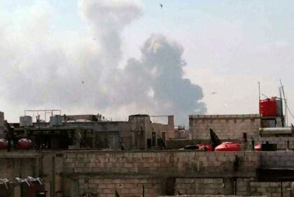 A handout picture released by the official Syrian Arab News Agency (SANA) on May 1, 2020, shows smoke billowing above buildings in Syria's central city of Homs. - SANA said that the explosions ringing out of a Syrian army position in Homs resulted from a "human error during the transport …