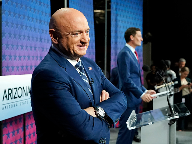 Arizona Democratic Sen. Mark Kelly, left, smiles as he stands on stage with Republican challenger Blake Masters, right, before a televised debate in Phoenix, Thursday, Oct. 6, 2022. (AP Photo/Ross D. Franklin)