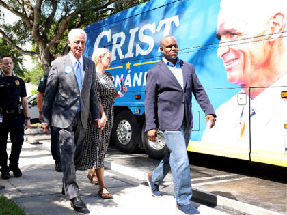 MIAMI, FLORIDA - OCTOBER 17: Charlie Crist, the Democratic gubernatorial candidate for Florida, walks with his fiancee Chelsea Grimes during a campaign stop at the Evelyn Greer Park on October 17, 2022 in Miami, Florida. Crist will face Republican Governor Ron DeSantis in the general election. (Photo by Joe Raedle/Getty …