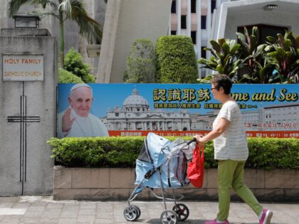 A woman walks past the Holy Family Catholic Church in Taipei on September 23, 2018. - Wors