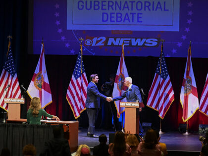Ron DeSantis, governor of Florida, and Charlie Crist, Democratic gubernatorial candidate for Florida, shake hands during the Florida gubernatorial debate in Fort Pierce, Florida, US, on Monday, Oct. 24, 2022. The debate, initially scheduled for Oct. 12, was postponed because of Hurricane Ian, a destructive Category 4 storm that struck …