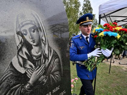 A Ukrainian serviceman brings flowers to a small coffin with the funeral urn of Mykhaylo Matyushenko, a colonel of Armed Forces of Ukraine, who was shot down in the sky over the Black Sea on June 26, 2022, during the funeral ceremony at the Heroes Alley of the cemetery of …