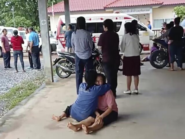 In this image taken from video, a distraught woman is comforted outside the site of an att