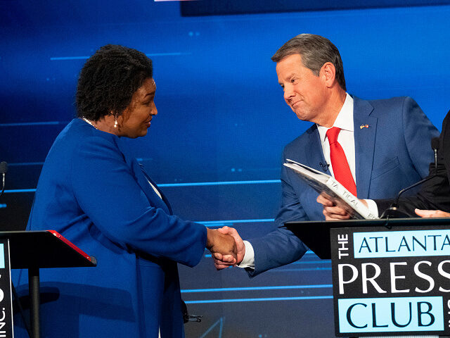 Democratic challenger Stacey Abrams, from left, shakes hands with Georgia Republican Gov.